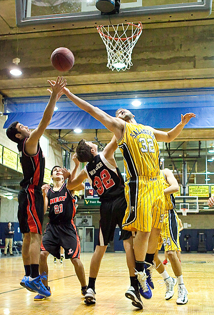 SAR Basketball's co-captain Samuel Marcus jostles among the Hillel Heat to grab a rebound on Sunday.
