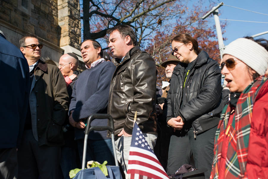 Several Riverdale residents originally from France sing the French national anthem, 'La Marseillaise,'  at the rally.